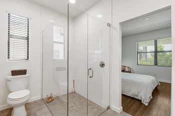 A bathroom with a shower and a bed